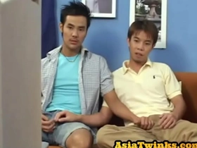 Young Japanese twink gives blow job before raw doggy sex in gay video.