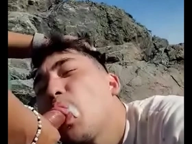 Young Asian girl gives a blow job outdoors