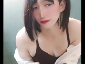 A feminine looking man in a porn video, a cross-dresser from Japan.